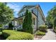 Beautiful two-story home with a covered front porch and a neatly maintained landscaped yard with a sidewalk at 647 East Ne Ave, Atlanta, GA 30312