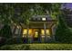 Inviting two-story home featuring a covered porch with bright lighting and lush landscaping, creating a warm ambiance at 647 East Ne Ave, Atlanta, GA 30312