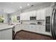 Modern kitchen featuring white cabinets, stainless steel appliances, and marble countertops at 647 East Ne Ave, Atlanta, GA 30312