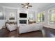 Inviting living room with hardwood floors, a cozy fireplace, and comfortable seating bathed in natural light at 647 East Ne Ave, Atlanta, GA 30312