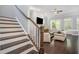 Open-concept living area featuring hardwood floors and staircase, with natural light and cozy decor at 647 East Ne Ave, Atlanta, GA 30312