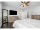 Spacious main bedroom with a ceiling fan, dark hardwood floors, dresser, and large mirror at 647 East Ne Ave, Atlanta, GA 30312