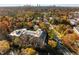Stunning aerial view of property surrounded by colorful fall foliage with the city skyline in the distance at 1717 N Decatur Ne Rd # 214, Atlanta, GA 30307