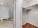 Bright bathroom featuring glass shower, soaking tub, and walk in closet at 1717 N Decatur Ne Rd # 214, Atlanta, GA 30307