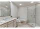 Bathroom featuring a glass enclosed shower, soaking tub, and double vanity at 1717 N Decatur Ne Rd # 214, Atlanta, GA 30307