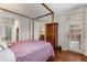 Bedroom showcasing four poster bed with views to bathroom, study, and doors to the outside at 1717 N Decatur Ne Rd # 214, Atlanta, GA 30307
