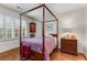 Bedroom featuring four poster bed, wood floors, shuttered windows, and classic decor at 1717 N Decatur Ne Rd # 214, Atlanta, GA 30307