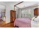 Bedroom with four poster bed and doors to the outside with a study and bathroom in view at 1717 N Decatur Ne Rd # 214, Atlanta, GA 30307