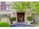 Elegant building entrance with lush landscaping, decorative lighting, and an ornate wooden door at 1717 N Decatur Ne Rd # 214, Atlanta, GA 30307