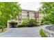 Elegant condo building with lush landscaping, a circular drive and covered parking area at 1717 N Decatur Ne Rd # 214, Atlanta, GA 30307