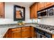 Kitchen featuring granite counters, stainless appliances, wooden cabinetry and hardwood floors at 1717 N Decatur Ne Rd # 214, Atlanta, GA 30307