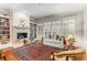 Bright living room with fireplace, built-in bookshelves, hardwood floors and many windows at 1717 N Decatur Ne Rd # 214, Atlanta, GA 30307