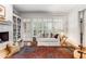 Comfortable living room with a fireplace, shelving, plantation shutters and an area rug at 1717 N Decatur Ne Rd # 214, Atlanta, GA 30307