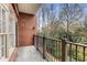 Private brick patio offering an intimate outdoor space with an iron railing and serene green view at 1717 N Decatur Ne Rd # 214, Atlanta, GA 30307