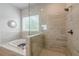 Elegant bathroom features a soaking tub, glass shower, and stylish fixtures at 2360 Charleston Manor Ln, Suwanee, GA 30024