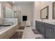 Elegant bathroom features a soaking tub, glass shower, dual sinks, and stylish tile flooring at 2360 Charleston Manor Ln, Suwanee, GA 30024