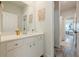 Stylish bathroom featuring a white vanity, large mirror, and 'XOXO' themed artwork at 2360 Charleston Manor Ln, Suwanee, GA 30024