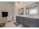 Elegant bathroom featuring dual sinks, stylish cabinets, quartz countertops, and modern fixtures at 2360 Charleston Manor Ln, Suwanee, GA 30024