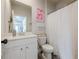 Charming bathroom with white vanity, mirror, shower/tub combo with curtain, and heart themed decor at 2360 Charleston Manor Ln, Suwanee, GA 30024