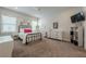 Bright bedroom featuring large windows, metal bed frame, string lights, and ample dresser storage at 2360 Charleston Manor Ln, Suwanee, GA 30024