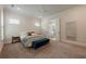 Spacious bedroom featuring plush carpet, ensuite access, and a stylish blue velvet bench at 2360 Charleston Manor Ln, Suwanee, GA 30024