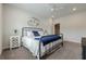 Cozy bedroom featuring a metal bed frame, neutral carpet, ceiling fan, and minimalist wall art at 2360 Charleston Manor Ln, Suwanee, GA 30024