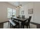 Formal dining room featuring wainscoting, a modern light fixture, and a large window at 2360 Charleston Manor Ln, Suwanee, GA 30024