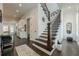 Elegant foyer with hardwood floors, staircase, and access to the kitchen and dining areas at 2360 Charleston Manor Ln, Suwanee, GA 30024