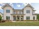 Charming two-story home with brick accents, a covered porch, and well-manicured lawn at 2360 Charleston Manor Ln, Suwanee, GA 30024