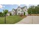 Traditional two-story home features a landscaped front yard and driveway at 2360 Charleston Manor Ln, Suwanee, GA 30024