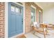 Close up view of the front porch with rocking chairs and a charming blue door at 2360 Charleston Manor Ln, Suwanee, GA 30024
