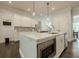 Kitchen island with stainless steel microwave and dishwasher with an eat-in island at 2360 Charleston Manor Ln, Suwanee, GA 30024