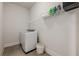 Functional laundry room with washer, dryer, and shelving for organized storage at 2360 Charleston Manor Ln, Suwanee, GA 30024