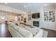 Open-concept living room with fireplace, modern furnishings, and hardwood floors at 2360 Charleston Manor Ln, Suwanee, GA 30024