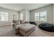 Comfortable sitting area featuring a gray couch, bean bag chairs, and natural light from windows at 2360 Charleston Manor Ln, Suwanee, GA 30024