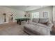 Spacious game room features a pool table and comfortable seating area, perfect for entertaining at 2360 Charleston Manor Ln, Suwanee, GA 30024