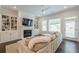 Living room features a fireplace, built-in shelving, and a comfortable sectional sofa at 2360 Charleston Manor Ln, Suwanee, GA 30024