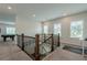 Bright loft space with a game area, and treadmill, illuminated by natural light through large windows at 2360 Charleston Manor Ln, Suwanee, GA 30024