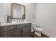 Stylish powder room featuring quartz countertops, sleek fixtures, and a modern mirror at 2360 Charleston Manor Ln, Suwanee, GA 30024