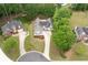 Serene neighborhood featuring mature trees, single-Gathering homes, and manicured lawns in a private community at 3187 Gainer Dr, Powder Springs, GA 30127