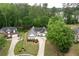 Charming home featuring manicured landscaping, a long driveway, and mature trees, providing shade and privacy at 3187 Gainer Dr, Powder Springs, GA 30127