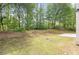 Large grassy backyard surrounded by mature trees at 3187 Gainer Dr, Powder Springs, GA 30127