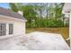 Concrete backyard patio next to house with lawn and treeline at 3187 Gainer Dr, Powder Springs, GA 30127