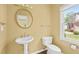 Well-lit half bathroom with pedestal sink and modern fixtures at 3187 Gainer Dr, Powder Springs, GA 30127