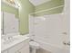 Well-lit bathroom with a white vanity, toilet, and a shower-tub combination at 3187 Gainer Dr, Powder Springs, GA 30127