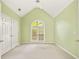 Bedroom featuring vaulted ceilings, large window, and light green walls at 3187 Gainer Dr, Powder Springs, GA 30127