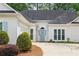 Charming single-story home featuring an arched front entrance, two-car garage and manicured landscaping at 3187 Gainer Dr, Powder Springs, GA 30127