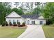 Charming single-story home featuring manicured shrubs and a well-maintained lawn and lovely blue shutters at 3187 Gainer Dr, Powder Springs, GA 30127