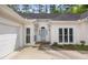 Charming single-story home featuring an arched front entrance, two-car garage and manicured landscaping at 3187 Gainer Dr, Powder Springs, GA 30127