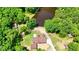 Aerial view of the property featuring a house, pond, outbuildings, and surrounding mature trees at 3340 Zingara Rd, Conyers, GA 30012